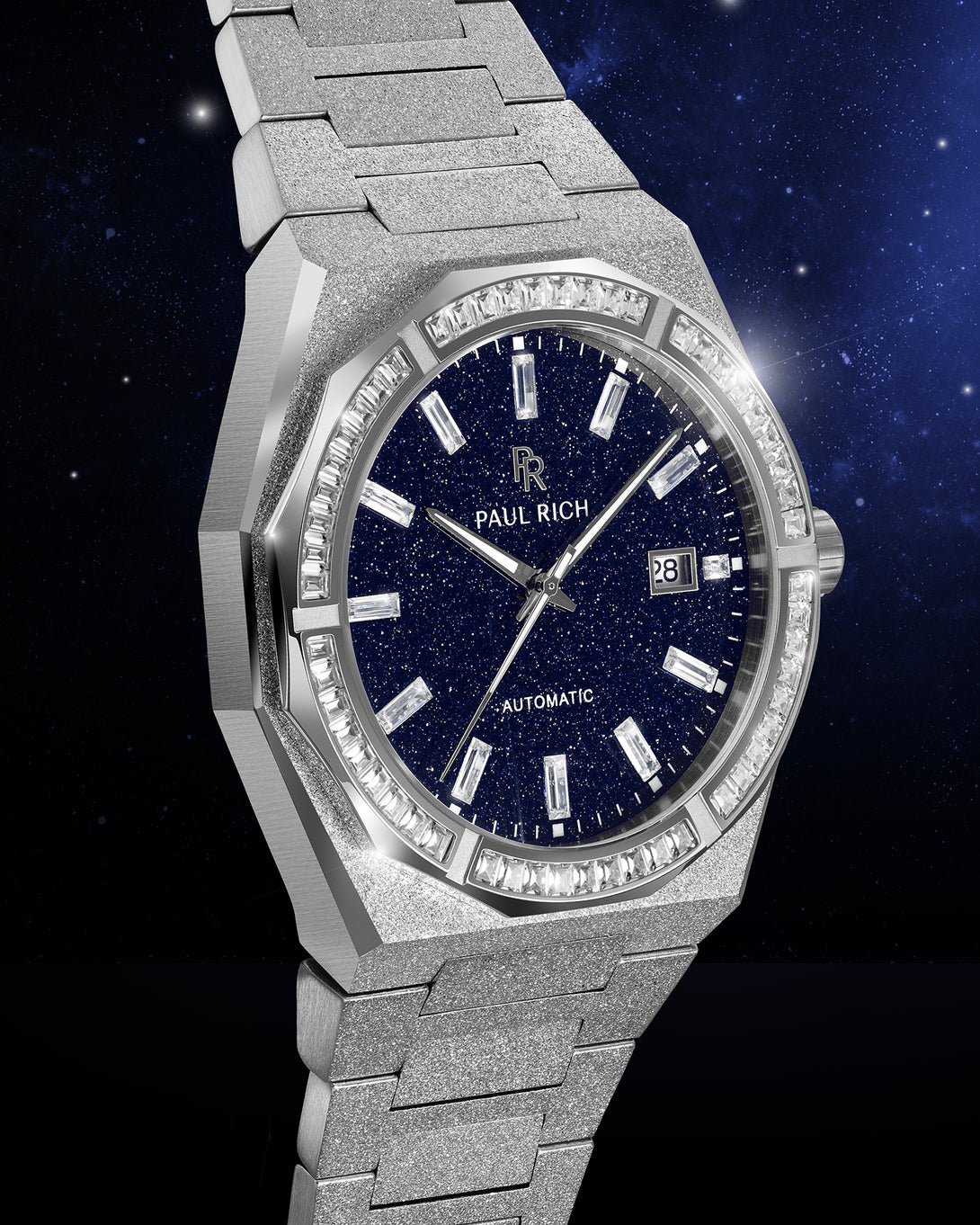 Silver frosted watch with blue aventurine dial, moissanite bezel, and date window shown at an angle against a deep starry background. Quartz | Automatic product_visual Silver frosted watch with blue aventurine dial, moissanite bezel, and date window shown at an angle against a deep starry background. Quartz | Automatic product_visual