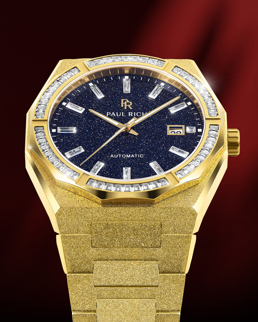 Gold frosted watch with blue aventurine dial, moissanite bezel, and date window at 3 o’clock shown under red studio lighting. Quartz | Automatic product_visual Gold frosted watch with blue aventurine dial, moissanite bezel, and date window at 3 o’clock shown under red studio lighting. Quartz | Automatic product_visual