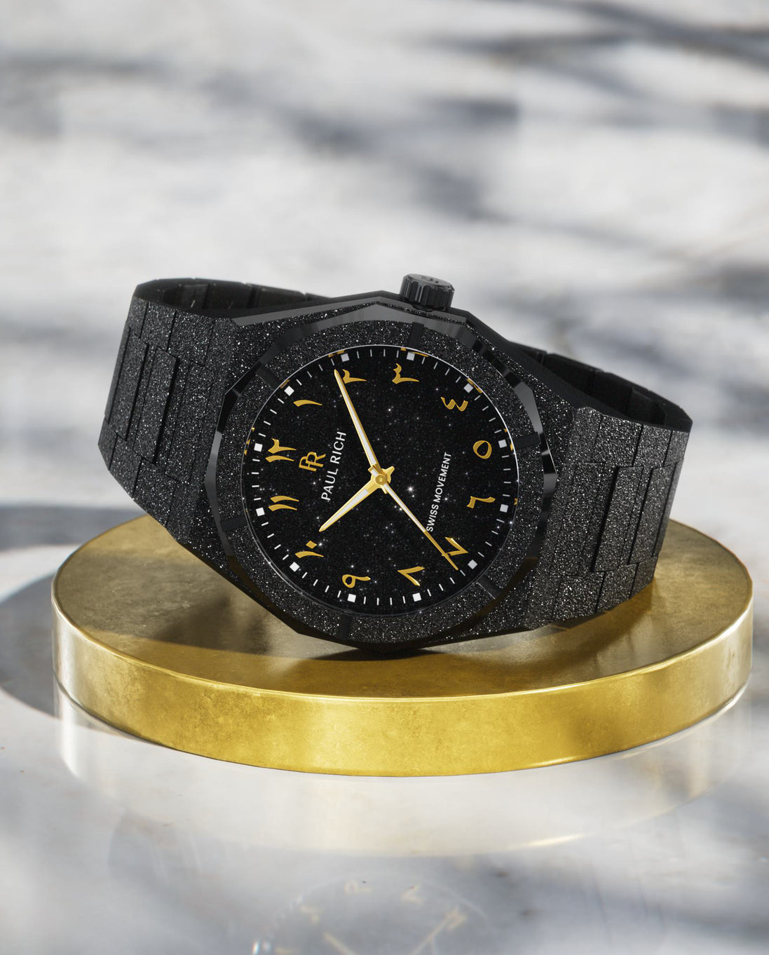 Paul Rich black frosted watch with black aventurine dial, gold Eastern Arabic numerals, and Swiss movement on black bracelet. product_visual Paul Rich black frosted watch with black aventurine dial, gold Eastern Arabic numerals, and Swiss movement on black bracelet. product_visual