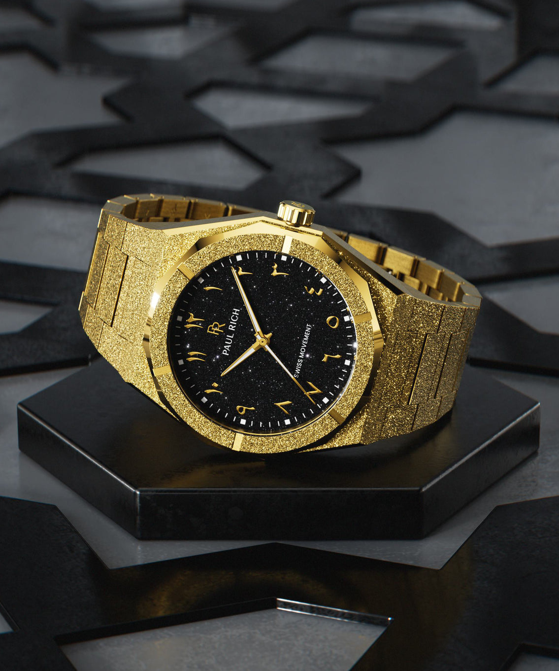 Paul Rich gold frosted watch with black aventurine dial and gold Eastern Arabic numerals, displayed on geometric black base. product_visual Paul Rich gold frosted watch with black aventurine dial and gold Eastern Arabic numerals, displayed on geometric black base. product_visual