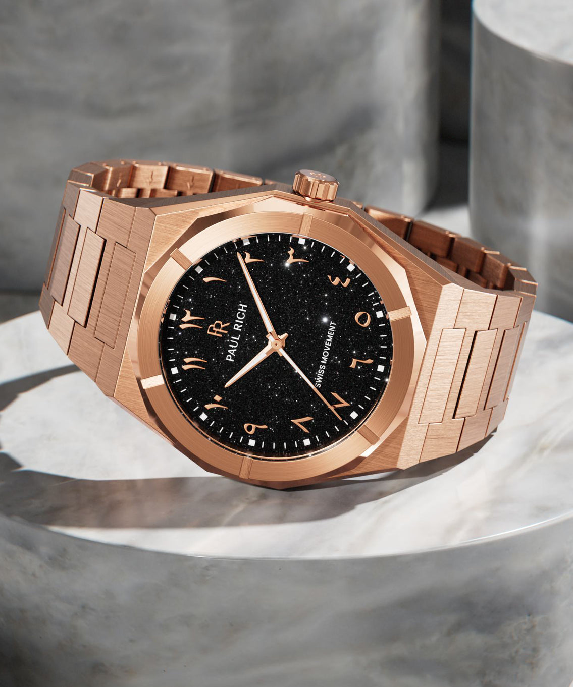 Paul Rich rose gold watch with black aventurine dial and Arabic numerals, displayed on polished stone, featuring Swiss movement. product_visual Paul Rich rose gold watch with black aventurine dial and Arabic numerals, displayed on polished stone, featuring Swiss movement. product_visual