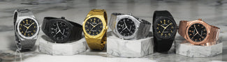 Five skeleton watches with lab-grown diamond bezels in silver, rose gold, gold, blue, and black cases on silicone straps and turquoise neon background.