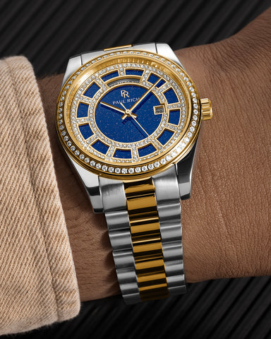 Two-tone silver and gold watch with a blue aventurine dial, pavé diamond bezel, and day–date display shown on a wrist with a matching bracelet. product_visual, [lifestyle]