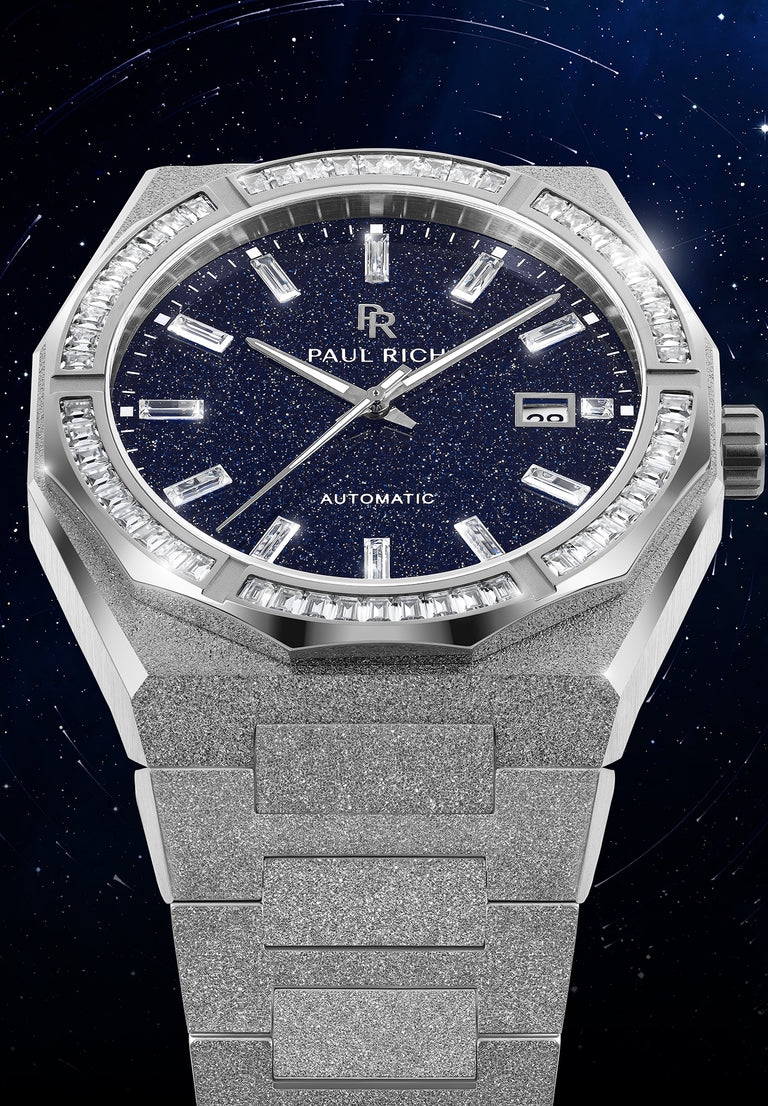 Silver frosted watch with blue aventurine dial, moissanite bezel, and date window at 3 o’clock displayed against a starry night background. Quartz | Automatic product_visual