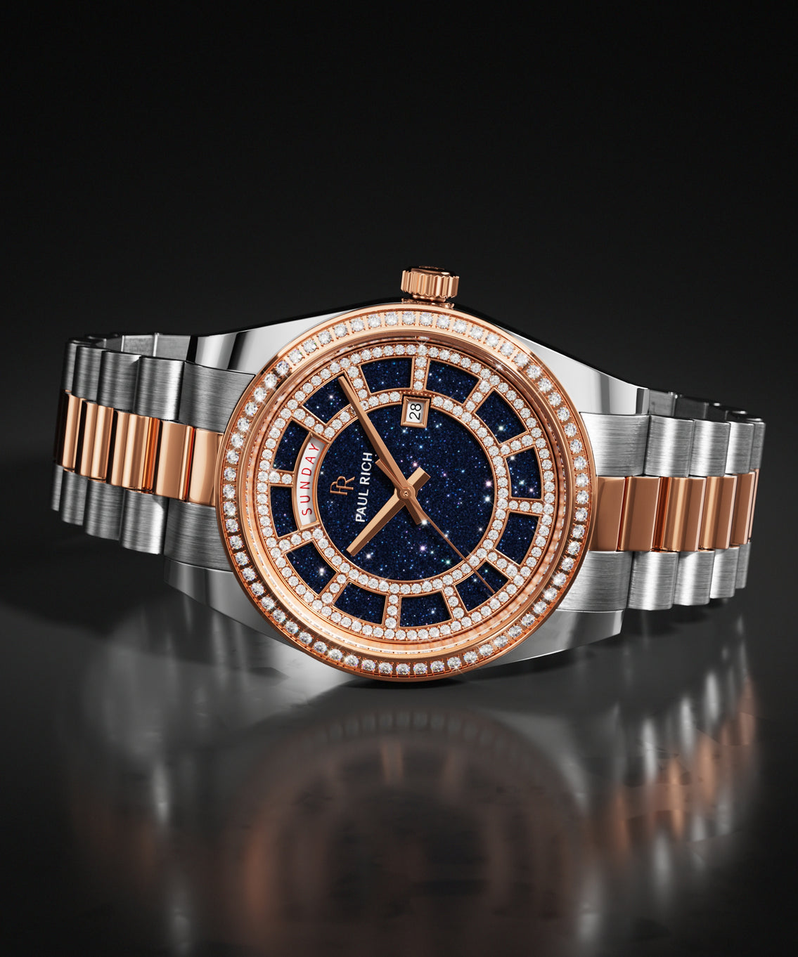 Rose gold and silver Paul Rich watch with a blue aventurine dial and stone-set bezel, shown on a two-tone steel bracelet against a dark background.