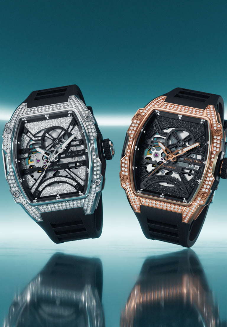Two skeleton watches with lab-grown diamond bezels in silver and rose gold cases on black silicone straps, set against turquoise neon.