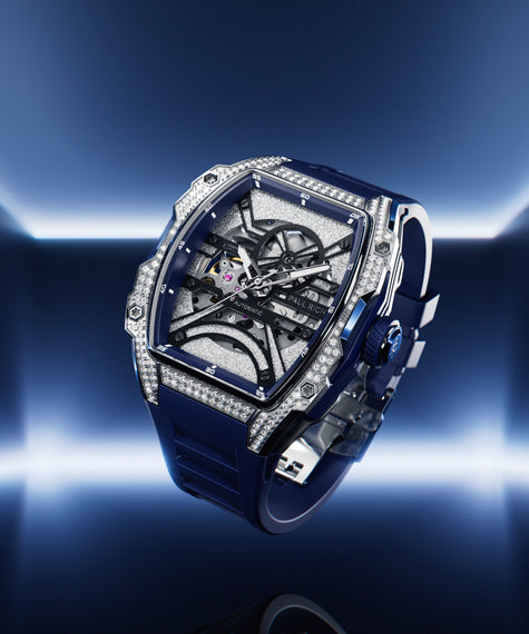 Angled view of open dial watch with diamond-set silver case and blue strap, shown on glowing blue gradient background. [lifestyle], product_visual