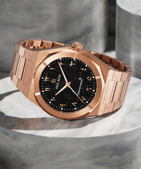 Paul Rich rose gold watch with black aventurine dial and Arabic numerals, displayed on polished stone, featuring Swiss movement. product_visual, [lifestyle]