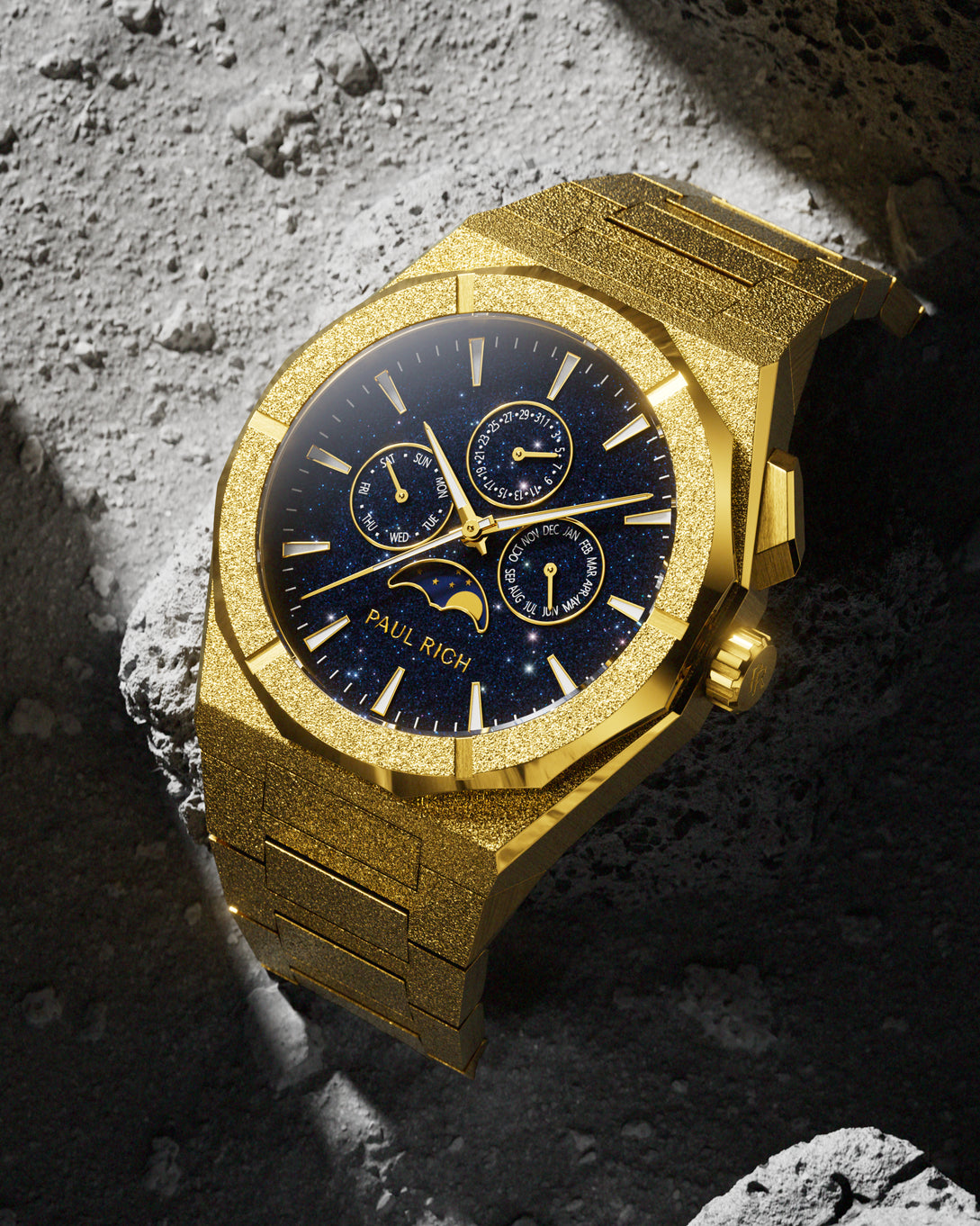 Frosted gold-tone stainless steel watch with blue aventurine dial, moonphase, and subdials, displayed on a geometric blue and gold backdrop. product_visual