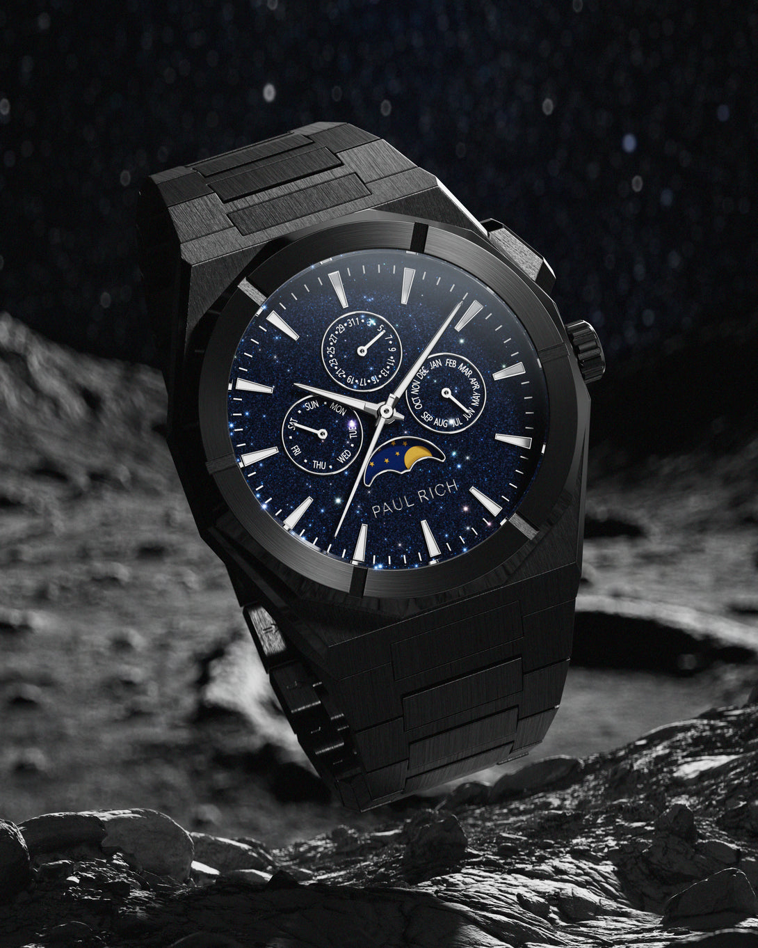 Brushed black stainless steel watch with blue aventurine dial, moonphase, and subdials, set against a rocky lunar surface and star-filled sky. product_visual
